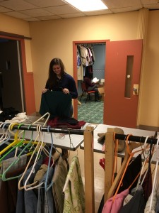 student organizing donated clothes