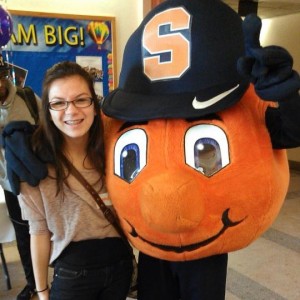 Student poses with Otto the Orange