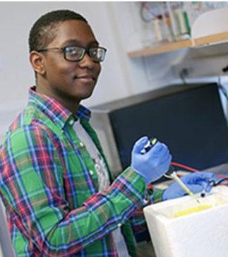 Student holding a pipette in a research lab