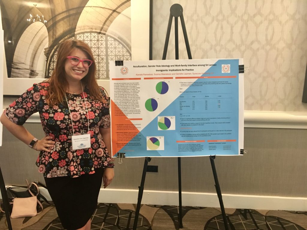 Danielle LIppman standing next to poster at conference
