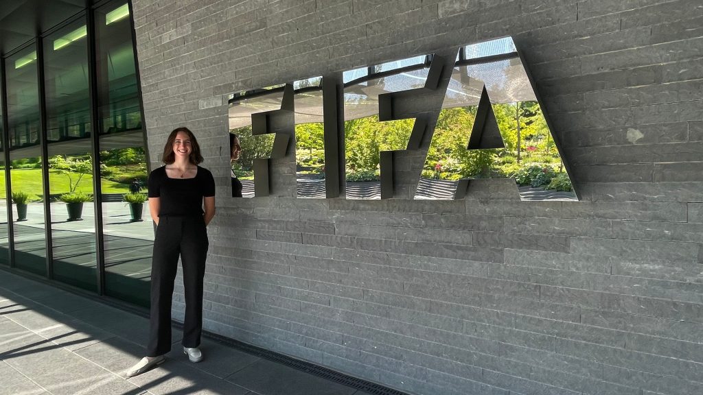 Charlotte poses in front of the FIFA Headquarters in Switzerland.