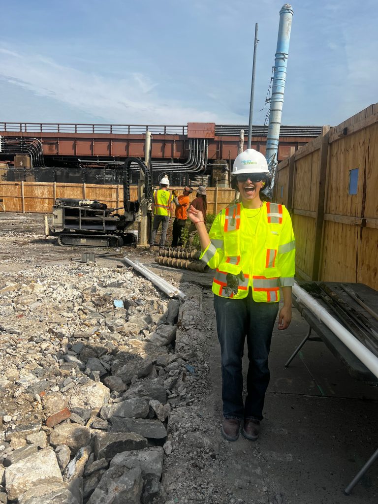 Ananya doing fieldwork with a construction crew.