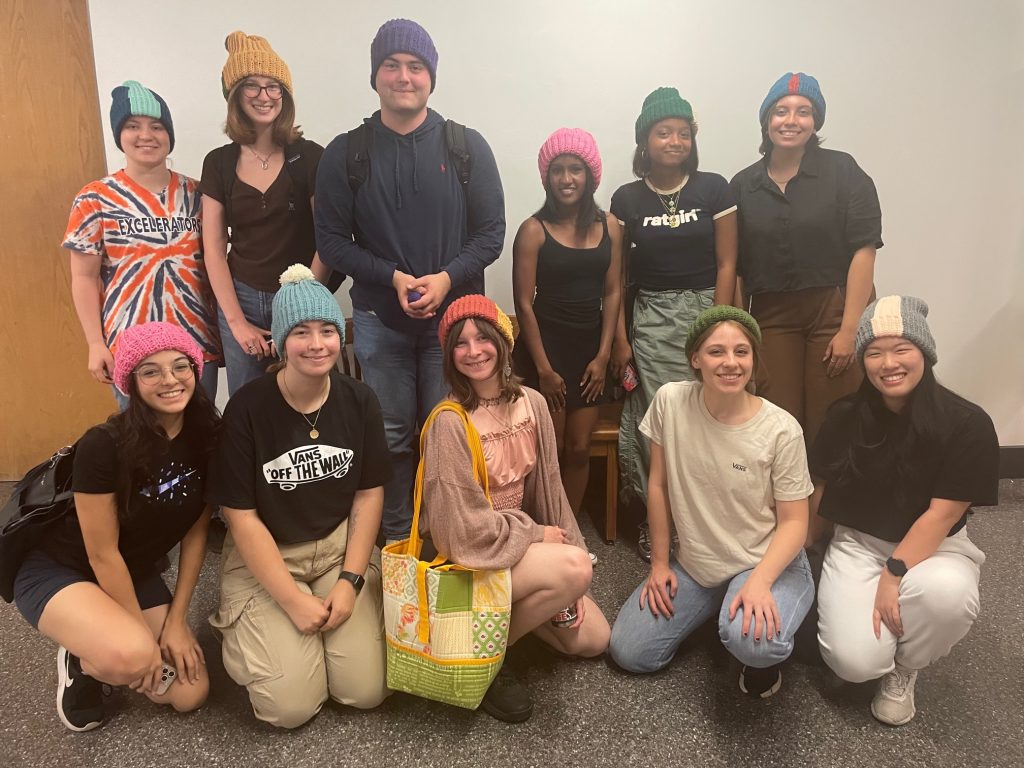 The students of HNR 210 show off their hats.